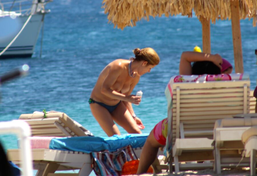 Free porn pics of Young redhead caught topless in Ornos beach, Mykonos 6 of 16 pics