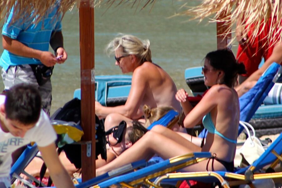 Free porn pics of Blonde mature caught topless in Psarou beach, Mykonos!! 9 of 9 pics