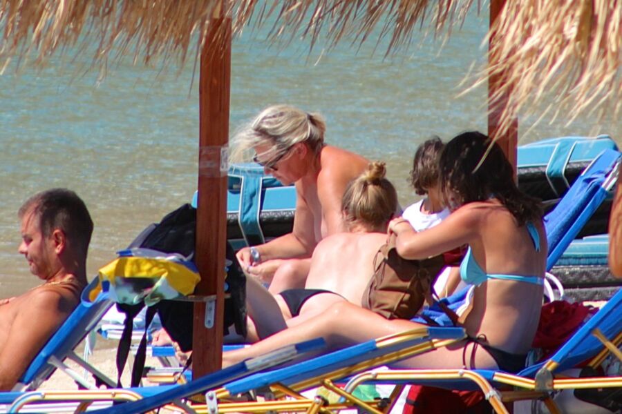 Free porn pics of Blonde mature caught topless in Psarou beach, Mykonos!! 1 of 9 pics
