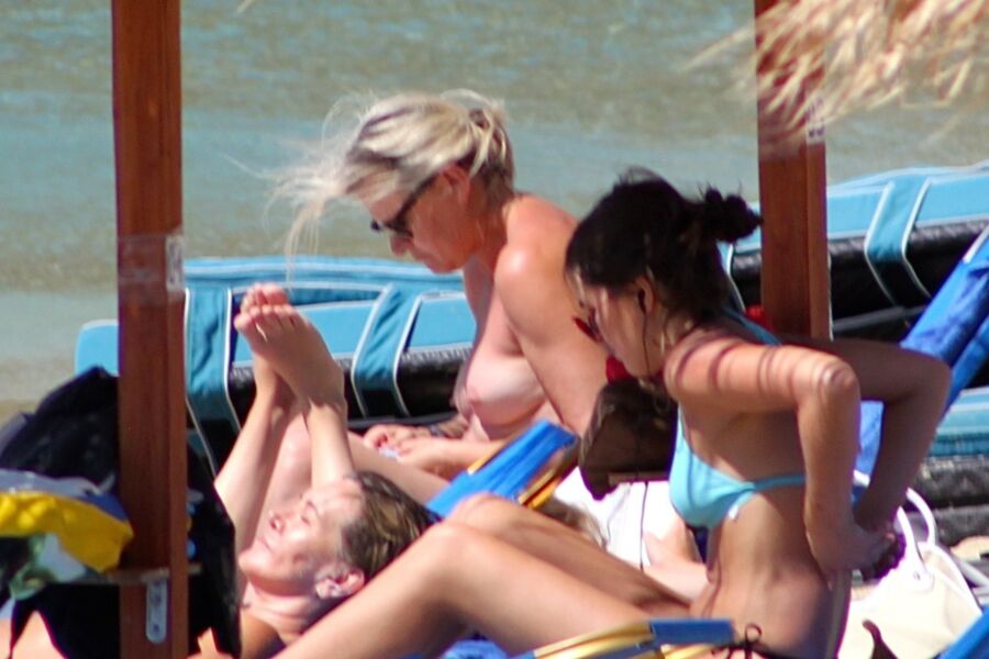 Free porn pics of Blonde mature caught topless in Psarou beach, Mykonos!! 4 of 9 pics