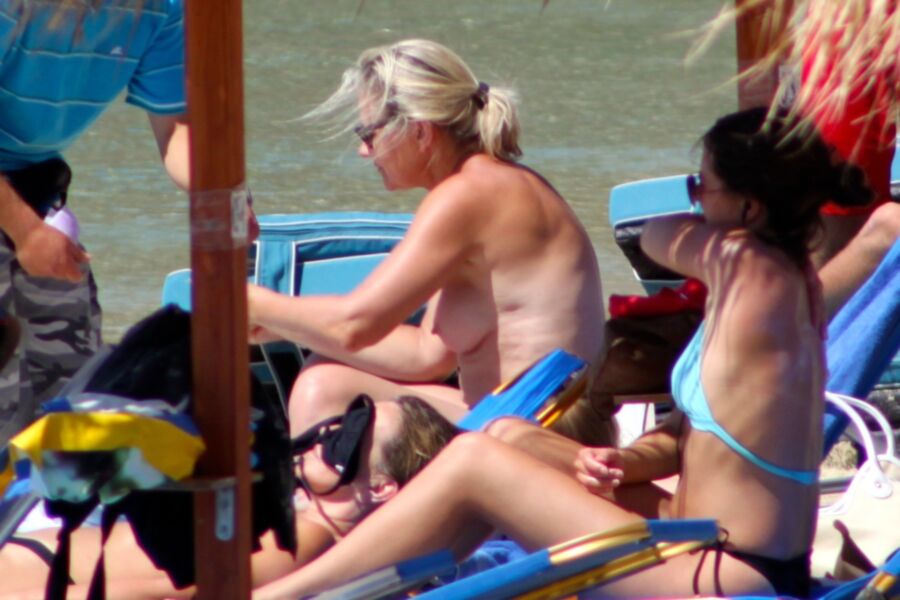 Free porn pics of Blonde mature caught topless in Psarou beach, Mykonos!! 8 of 9 pics