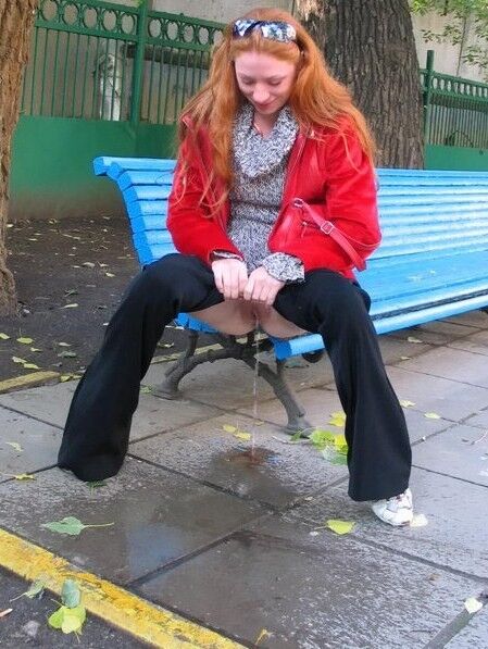 Free porn pics of Young mature redhead pulls down trousers and pisses on the stree 7 of 15 pics